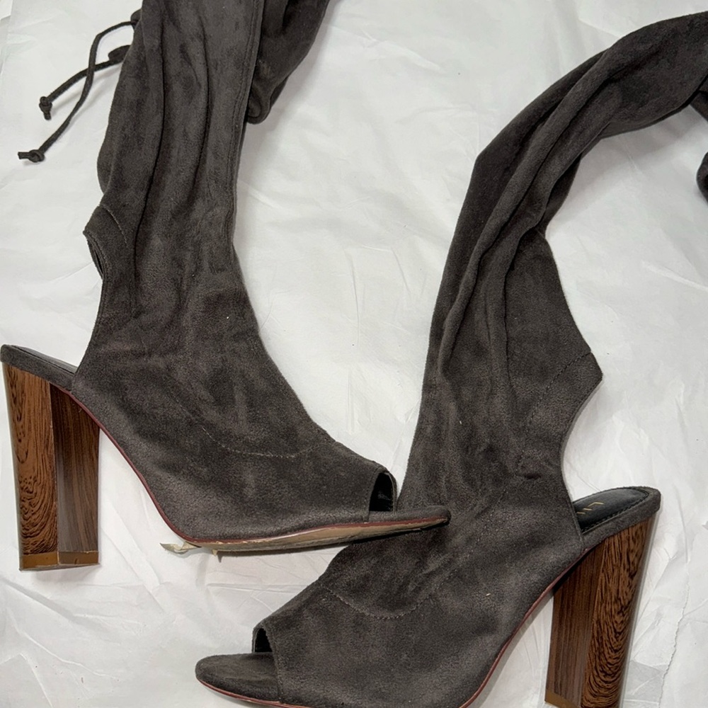 High knee long open toe boots.